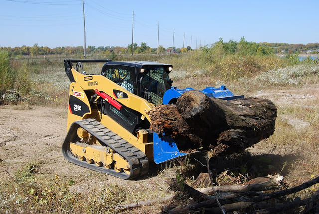 Demo Dozer product family demonstration handling a log with a compact track loader