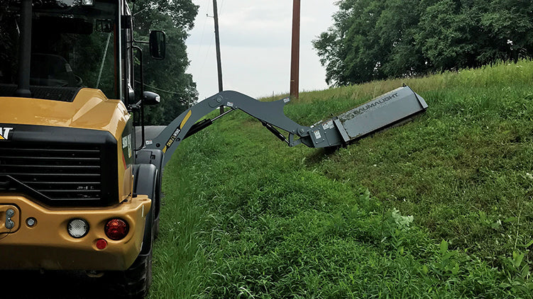 Baumalight boom mower on cat wheel loader