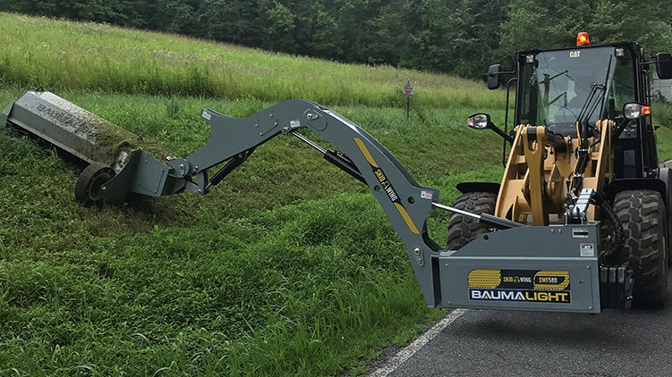 Wing mower on cat wheel loader